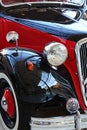 Right black splasher with rearview mirror, headlight and winker on massive fender of oldtimer veteran vehicle Citroen Traction