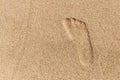 Right foot print in yellow sand. top view