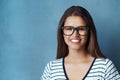 The right frames make the world of difference. Studio shot of an attractive young woman posing against a blue background