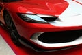 Right front view of elegant headlights and front mask of italian plug-in hybrid sports car Ferrari 296 GT Royalty Free Stock Photo