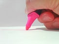 Right hand holding pink highlighter pen Royalty Free Stock Photo