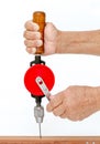 Right hand hold and left hand spin hand drill for drilling wooden on white background. Royalty Free Stock Photo