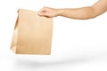 Right hand holding a brown paper bag  on white with clipping path Royalty Free Stock Photo