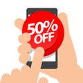 Right hand holds smartphone. fifty percent discount purchase on online