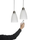 Right hand of woman with black pullover taking a light bulb and two white and silver lamps hang Royalty Free Stock Photo