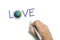 Right hand writing 'LOVE' and the earth