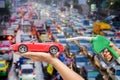 Right hands of men who were holding an automatic nozzle to make refill oil on red toy car on left hand Royalty Free Stock Photo