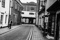Loan woman seen walking down a deserted side-street in an English town.