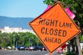 Right Lane Closed Ahead warning road sign on wide city street in urban neighborhood