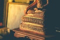 The right on the left hand, waist of Buddha image, sitting position, gold color on wooden table with sunlight Royalty Free Stock Photo