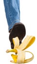 Right leg in jeans and shoe stepping on banana Royalty Free Stock Photo
