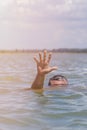 Right man`s hand gives a signal for help out of the water Royalty Free Stock Photo