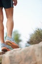 The right pair of shoes is a hikers best friend. Cropped image of a hikers legs standing on a rock - copyspace.