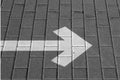 Right pointing arrow on asphalt in black and white