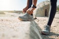 The right shoes determine your run. a woman tying her shoe laces before a jog.