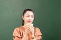 Right side of beautiful Asian woman customer sits blankly while drinking coffee in coffee shop Royalty Free Stock Photo