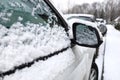 Right side of the car, door and SUV side mirror covered in snow and ice in winter. Royalty Free Stock Photo