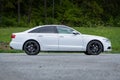 Right-side profile of Audi A6 of the year 2014 S-Line, white metallic paint and black rims