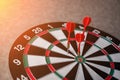 Right on target concept using dart in the bullseye on dartboard Royalty Free Stock Photo