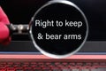 right to keep and bear arms text written through a magnifying glass on a black laptop screen Royalty Free Stock Photo