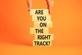 Right track symbol. Concept words Are you on the right track on wooden blocks on a beautiful orange table orange background.