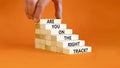 Right track symbol. Concept words Are you on the right track on wooden blocks on a beautiful orange table orange background.