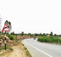 Right turn sign board on a highway at a right curve on road Royalty Free Stock Photo