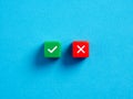 Right versus wrong. To approve or to reject. Decision making concept. Checkmark and cross symbols on colorful cubes on blue Royalty Free Stock Photo