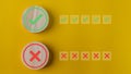 Right and wrong or voting yes or no concept. Wooden blocks with check marks on a yellow background. The idea of choice