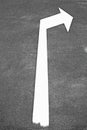 Righthand white arrow on black asphalt. Royalty Free Stock Photo