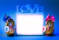 Two funny gnomes and love frame on a blue background