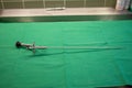 rigid uretheroscope for the examination of ureters lies on a green surgical drape