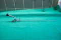 rigid uretheroscope for the examination of ureters lies on a green surgical drape