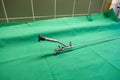 rigid uretheroscope for the examination of ureters lies on a green surgical drape