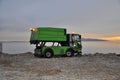 Rijeka, Croatia February 2021. Garbage Day Pickup. Garbage truck caught in action emptyÃ¢â¬â¢s a trash bin in front of the sea. Royalty Free Stock Photo