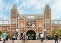 Rijksmuseum building facade with tourists and cyclists in Amsterdam Royalty Free Stock Photo