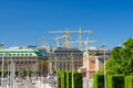 Riksplan, bushes and street with national flags on Sodermalm island, Gustav Adolfs torg square, Royal Swedish Opera house building Royalty Free Stock Photo