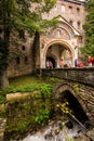 Entrance bridge to the Rila Monastery with passing tourists Royalty Free Stock Photo