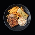 rilled Chicken Chop with french fries served in a dish side view on black background fast food