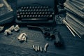 ÃÂ¡rime fiction story - old retro vintage typewriter and revolver gun with ammunitions, books, blank paper, old ink pen. Split tone Royalty Free Stock Photo