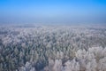 Rime and hoarfrost covering trees. Aerial view of the snow-covered forest and lake from above. Winter scenery. Landscape photo Royalty Free Stock Photo