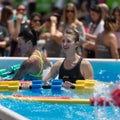 Rimini, Italy - june 2019: Girls Doing Water Aerobics with Floating Pool Dumbbells Outdoor in a Swimming Pool