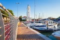 Rimini, Italy. Lighthouse in sea port of Rimini. Boats moored in harbor Royalty Free Stock Photo