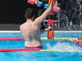Rimini, Italy - may 2019: Boy Doing Water Aerobics with Floating Pool Dumbbells Outdoor in a Swimming Pool