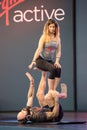 Rimini, Italy - may 2019: Couple Practicing Yoga and Fitness: Girl in Balance Position on PartnerÃ¢â¬â¢s Legs