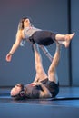 Rimini, Italy - may 2019: Couple Practicing Yoga and Fitness: Girl in Balance Position on PartnerÃ¢â¬â¢s Legs