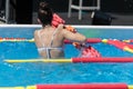 Rimini, Italy - may 2019: Girl Doing Water Aerobics with Floating Pool Dumbbells Outdoor in a Swimming Pool