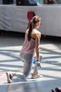 Rimini, Italy - may 2019: Girl Exercising with Plastic Water Bottle in Class at Gym with Music and Teacher on Stage