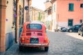 Rimini, Italy, September 19, 2018: retro vintage car Fiat 500 L red parked on cobblestone street
