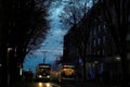 Rincipal street in Zurich center with two trams in typical blue color passing past each other.